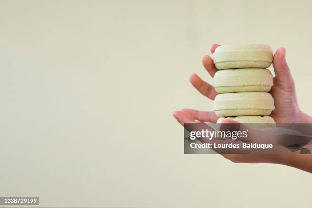 stack of organic soap and shampoo in hands - solid soap stock pictures, royalty-free photos & images
