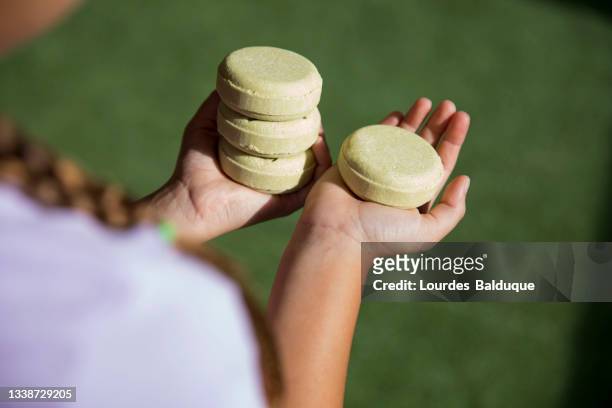 stack of organic soap and shampoo in hands - bar soap stock pictures, royalty-free photos & images