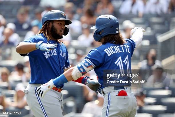 Vladimir Guerrero Jr. #27 celebrates his first inning home run with teammate Bo Bichette of the Toronto Blue Jays during a game aginst the New York...