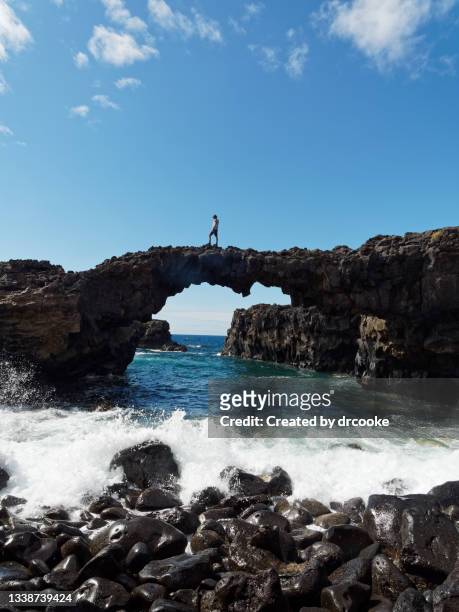 one teenager on a natural volcanic arch above the sea - hierro bildbanksfoton och bilder