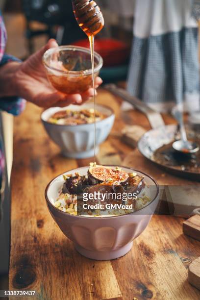 healthy yogurt with caramelized figs, honey and pistachio - pistachio stock pictures, royalty-free photos & images