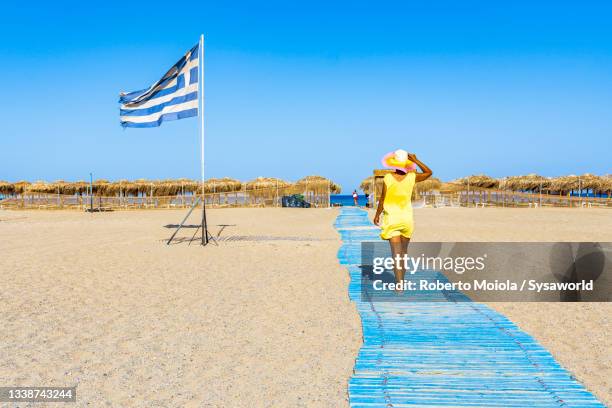 beautiful woman walking on the beach, crete, greece - crete woman stock pictures, royalty-free photos & images