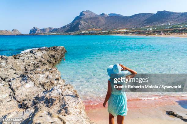 charming woman in the crystal sea, falasarna beach, crete - crète photos et images de collection