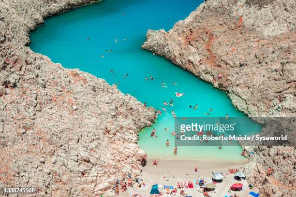 people swimming in the crystal lagoon, crete, greece - akrotiri stockfoto's en -beelden