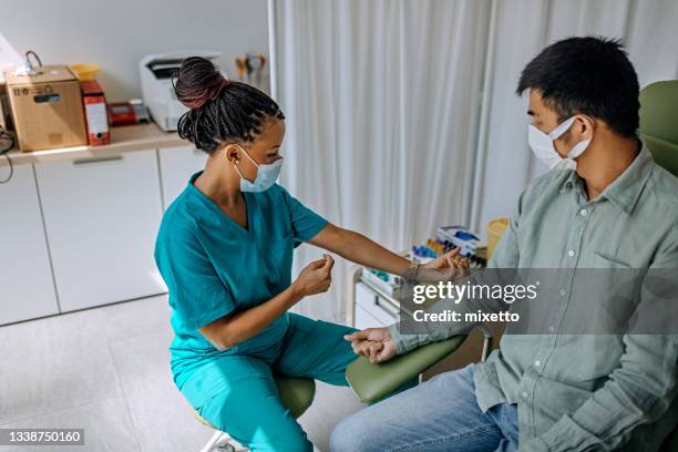 nurse preparing patient to do a blood analysis - global health stock pictures, royalty-free photos & images