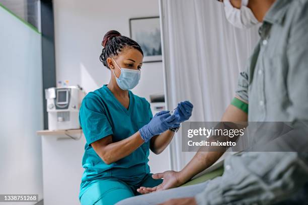 krankenschwester bereitet patienten auf eine blutanalyse vor - preparing drug in hospital nurse stock-fotos und bilder