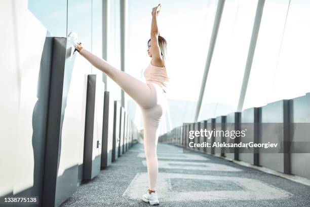 beautiful female athlete doing stretching exercises on bridge outside - beautiful bums imagens e fotografias de stock