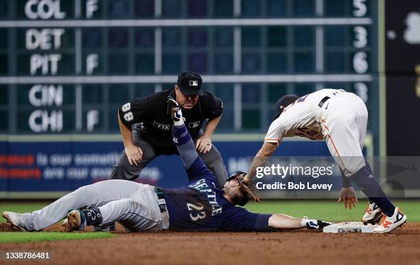 Jose Altuve of the Houston Astros tags Ty France of the Seattle Mariners out at second base in the sixth inning as umpire Doug Eddings makes the call...