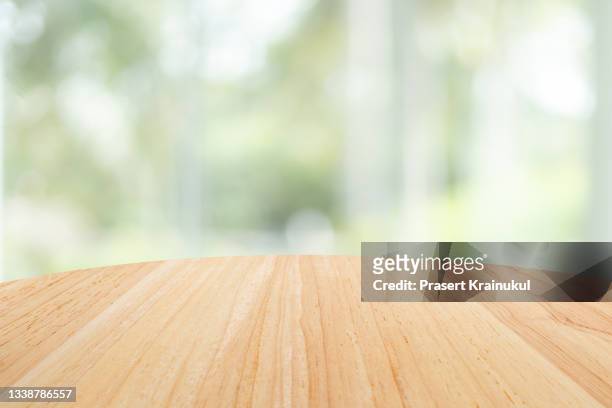 empty round wood table top and blur glass window wall building. banner mock up abstract background - table stock-fotos und bilder