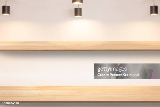 wood shelfs on white concrete wall background with downlight - downlight stock pictures, royalty-free photos & images