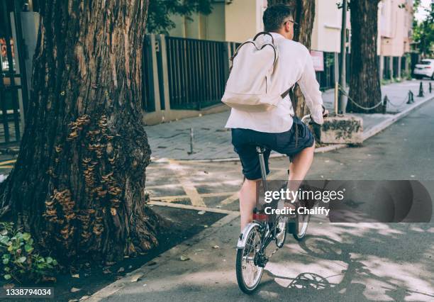 commuting in a green way - foldable stock pictures, royalty-free photos & images