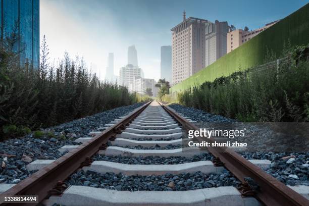 train tracks in the city center - railroad track stock pictures, royalty-free photos & images