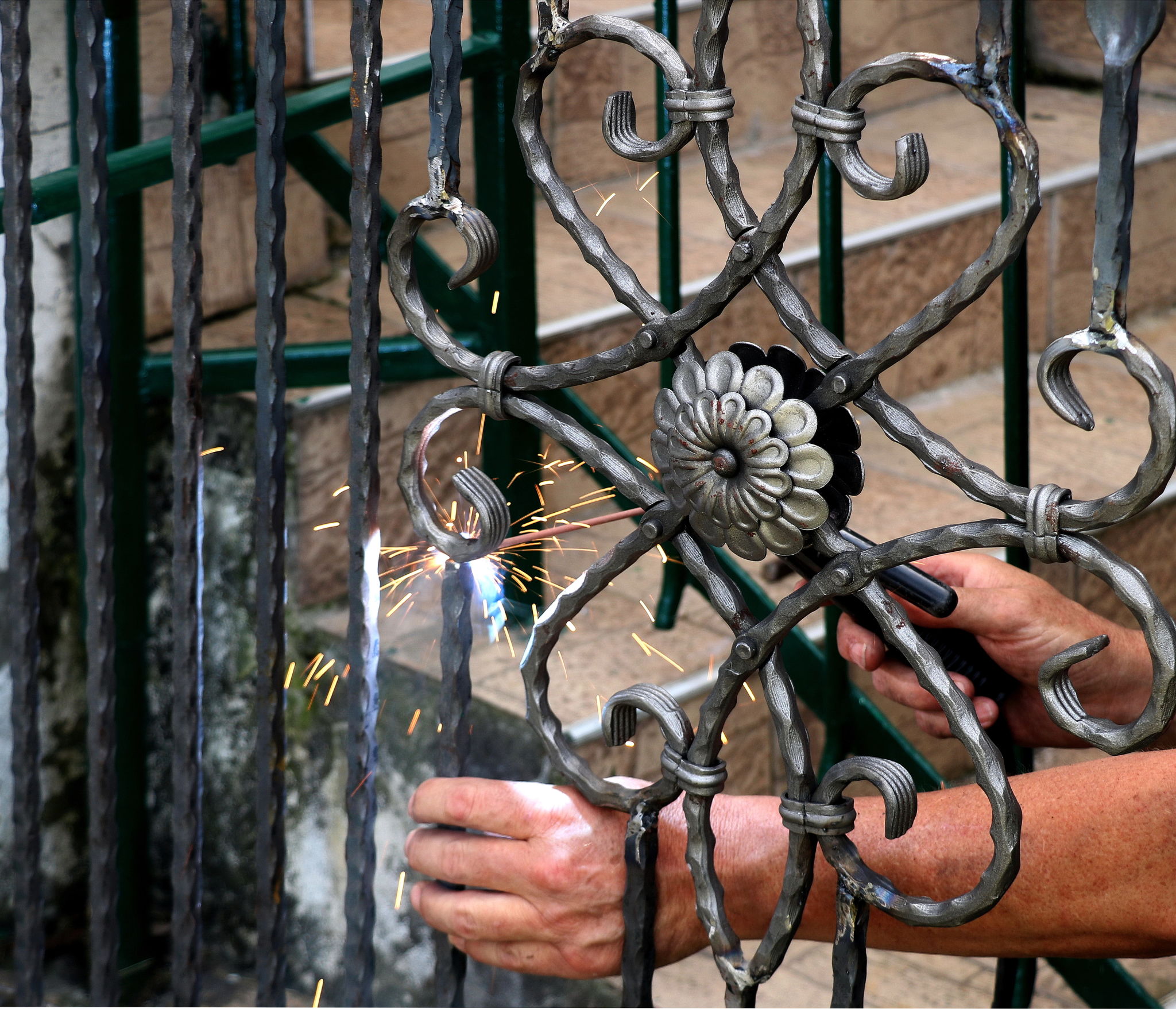 Welder at work, welding metal gate Welder at work, welding metal gate