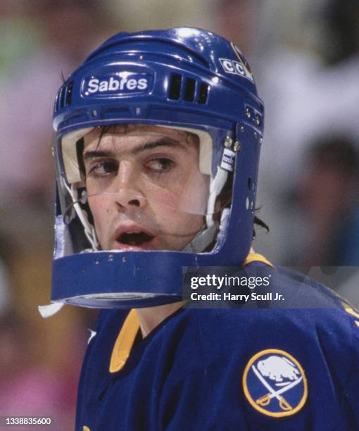 Pat LaFontaine, Captain and Center for the Buffalo Sabres wearing a protective aluminium face guard attachment to his helmet looks on during the NHL...