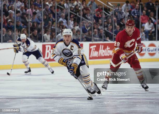 Alexander Mogilny from Russia and Captain, Right Wing for the Buffalo Sabres in motion on the ice skating past Paul Ranheim of the Calgary Flames...