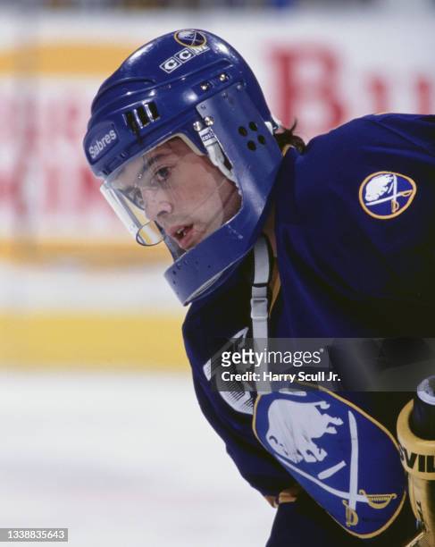 Pat LaFontaine, Captain and Center for the Buffalo Sabres wearing a protective aluminium face guard attachment to his helmet looks on during the NHL...