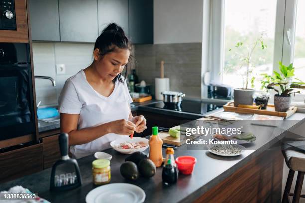 female sushi chef in her kitchen preparing crab for sushi - shrimp edamame stock pictures, royalty-free photos & images