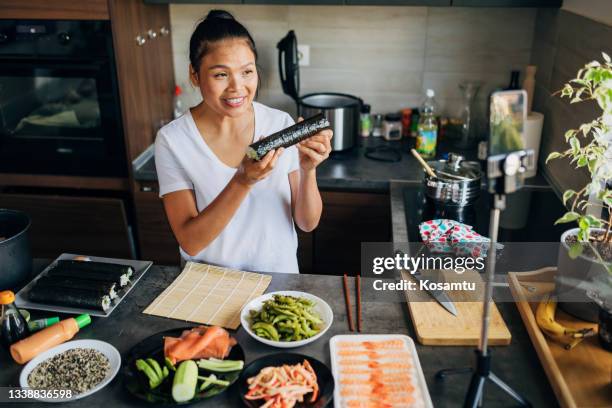 proud thai woman, showing to her followers how her traditional sushi rolls turned out, while recording her food vlog - shrimp edamame stock pictures, royalty-free photos & images