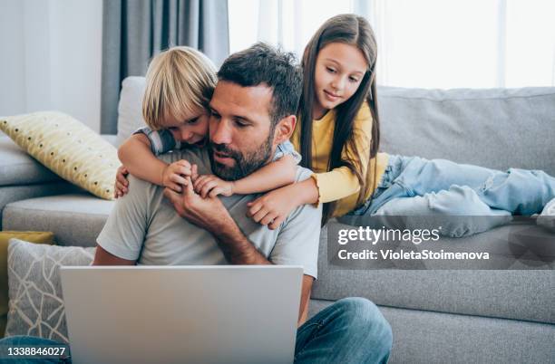 father trying to work from home. - quarantine work stock pictures, royalty-free photos & images