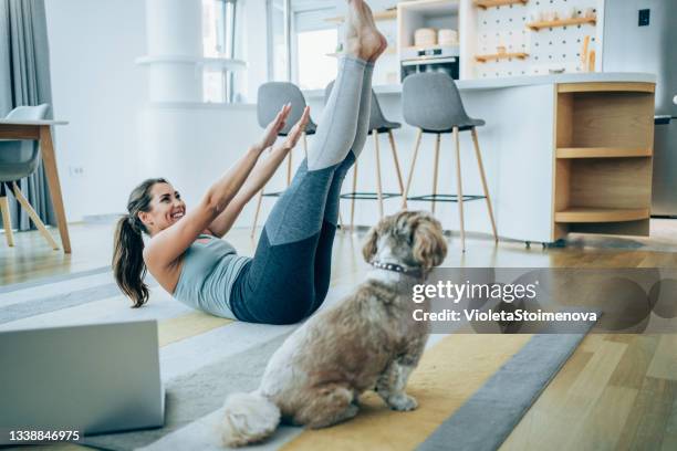 sporty woman exercising at home. - bodyweight training stock pictures, royalty-free photos & images