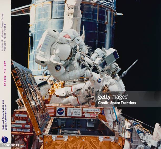 Gearing up with tools for the first Extravehicular Activity to service the Hubble Space Telescope are astronauts Steven L Smith and Mark C Lee,...