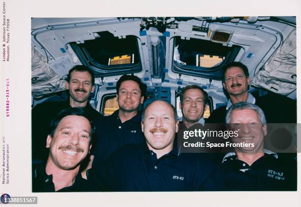 On Discovery's aft flight deck, the STS-82 astronauts pose for the traditional inflight crew portrait, 11th-21st February 1997. Front row, left to...
