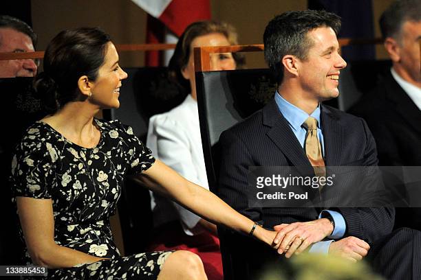 Prince Frederik of Denmark and Princess Mary of Denmark hold hands during their attendance at a luncheon given by Prime Minister Julia Gillard at...