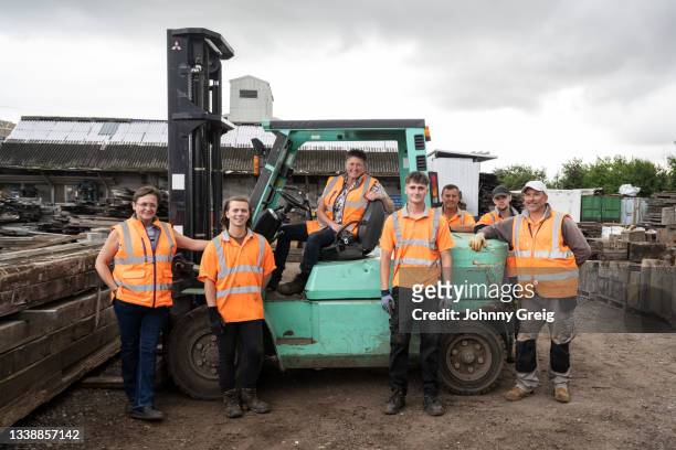 group portrait of reclaimed timber business owner and staff - organized group photo stock pictures, royalty-free photos & images