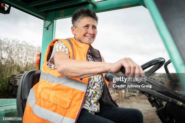 close-up of business owner working outdoors at lumberyard - femalefocuscollection stock-fotos und bilder