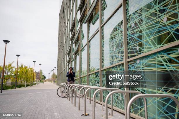 businessman arriving at work - bicycle rack stock pictures, royalty-free photos & images
