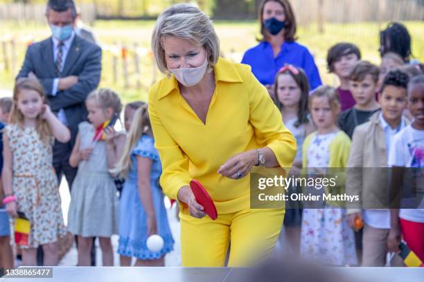 Her Majesty Queen Mathilde of Belgium practices her table tennis skills with the pupils during a visit to the KAZ “Koninklijk Atheneum Zottegem”...