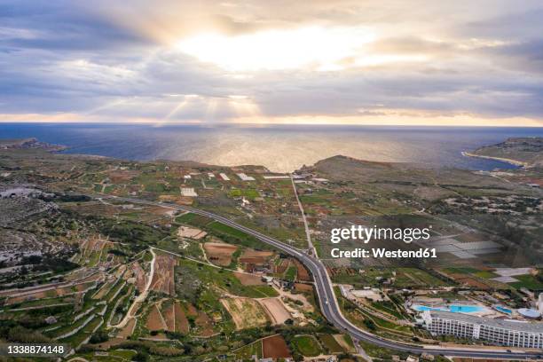 malta, northern region, mellieha, aerial view of coastal fields and farms at sunset - mellieha malta stock pictures, royalty-free photos & images