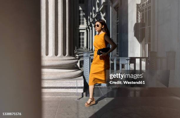 woman running through arcade at national gallery, singapore - art gallery exterior stock pictures, royalty-free photos & images