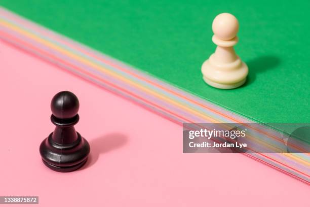 white pawn and black pawn - chess piece stock pictures, royalty-free photos & images