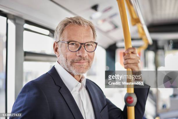 bearded businessman traveling by bus - öffentliches verkehrsmittel stock-fotos und bilder