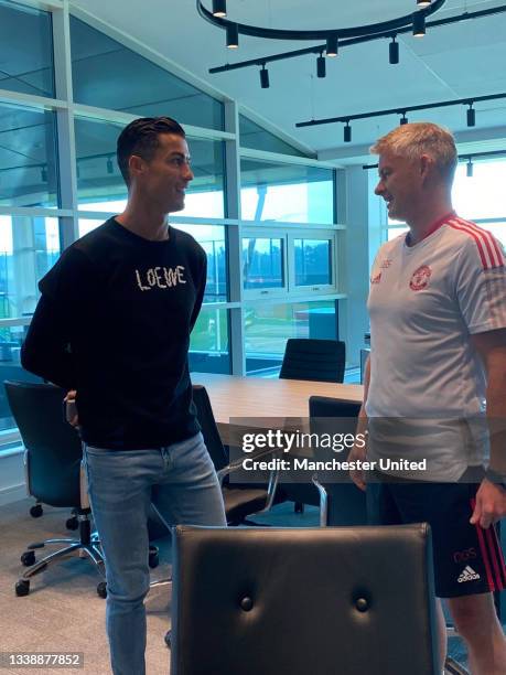 Manager Ole Gunnar Solskjaer of Manchester United meets Cristiano Ronaldo at Carrington Training Ground on September 07, 2021 in Manchester, England.