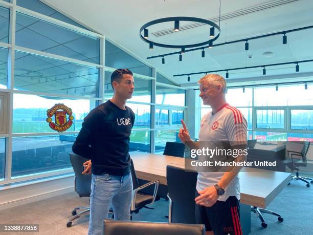 Manager Ole Gunnar Solskjaer of Manchester United meets Cristiano Ronaldo at Carrington Training Ground on September 07, 2021 in Manchester, England.