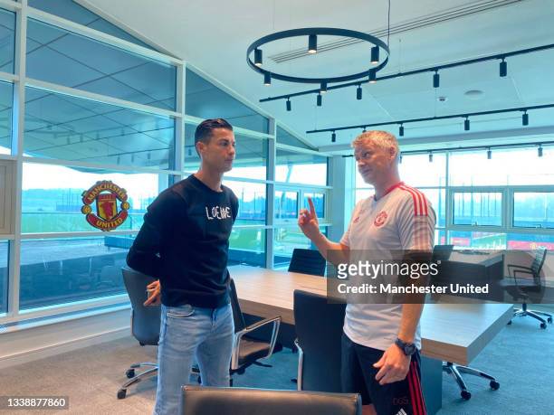 Manager Ole Gunnar Solskjaer of Manchester United meets Cristiano Ronaldo at Carrington Training Ground on September 07, 2021 in Manchester, England.