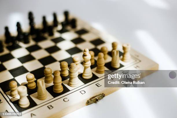 chess board with figures on white background. - queen chess piece stock pictures, royalty-free photos & images