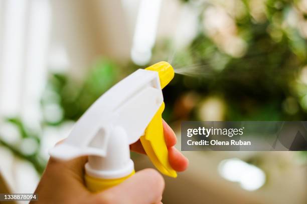 hand spraying water on plants. - crop sprayer imagens e fotografias de stock