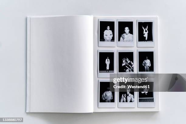 polaroid photographs album on white background - fotoalbum stockfoto's en -beelden