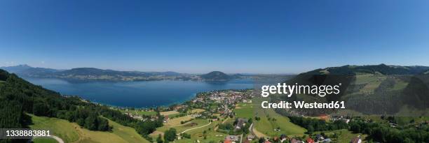 austria, upper austria, weyregg am attersee, drone panorama of small town on shore of lake atter - attersee stock pictures, royalty-free photos & images