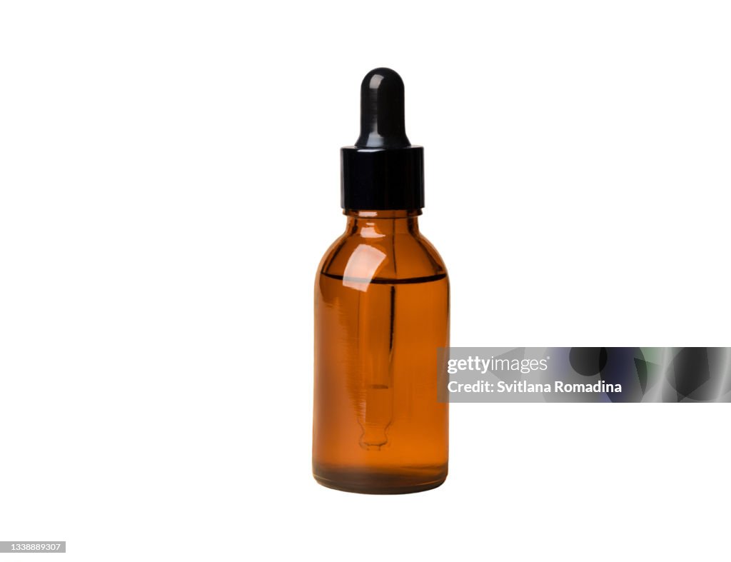 Glass cosmetic bottle against white background