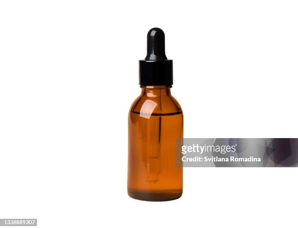 glass cosmetic bottle against white background - massage oil stock pictures, royalty-free photos & images