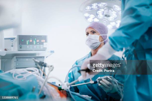 medical team performing gastric bypass surgery - surgery stock pictures, royalty-free photos & images
