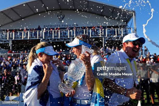 Matilda Castren of Team Europe and Madelene Sagstrom of Team Europe celebrate with the Solheim Cup after winning over Team USA during day three of...