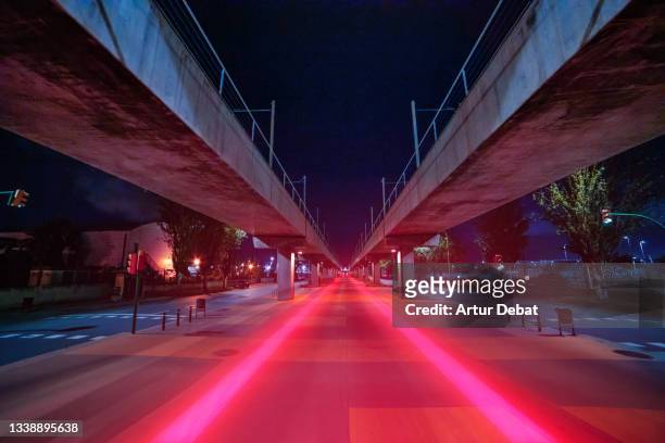 red light trails in stunning urban road with diminishing perspective. - barcellona night foto e immagini stock