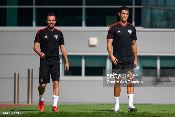 Juan Mata and Cristiano Ronaldo of Manchester United in action during a first team training session at Carrington Training Ground on September 07,...