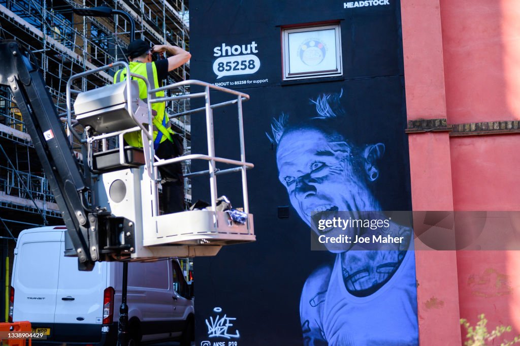 Prodigy Mural Rapper Street artist Akse P19 takes photos of his finished work during the ...