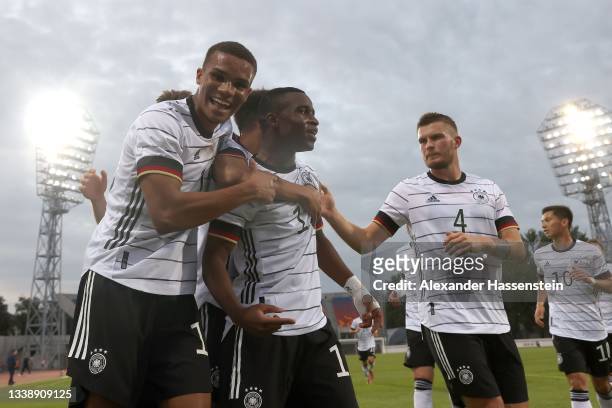Youssoufa Moukoko of Germany celebrates scoring the 1st team goal with his team mates Malick Thiaw and Lars Lukas Mai during the UEFA European...